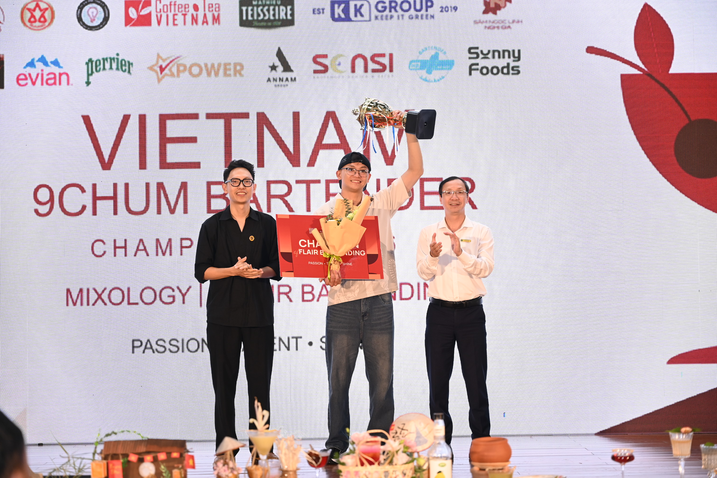 Ông Đào Việt Hà (bên phải), Phó Hiệu trưởng trường CĐ Xây dựng Công trình Đô thị trao Cúp cho thí sinh Lương Quang Tùng - Bartender Đà Nẵng giải Nhất phần thi Flair Bartending. 